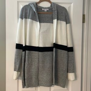 Black, grey, and white hooded cardigan sweater.